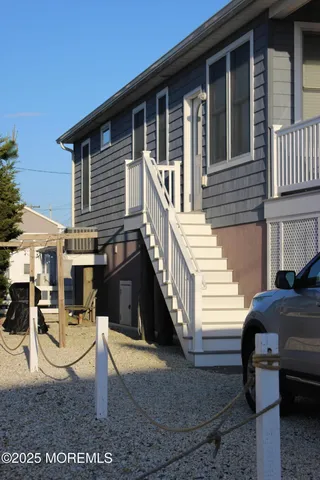 a view of a house with a chairs in patio