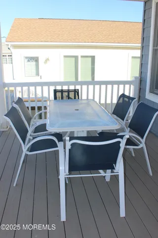a view of a dining room with furniture and a large window