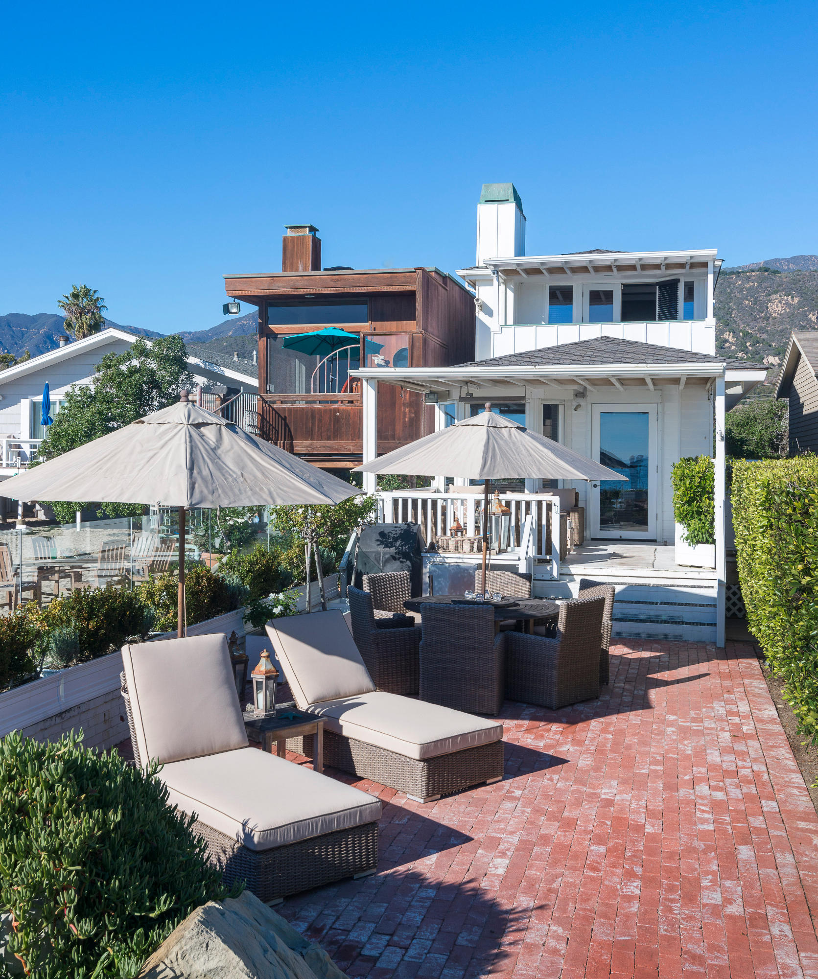3555.5 Padaro Lane Carpinteria, CA 93013 - Photo 14 of 20 a view of a patio with couches table and chairs under an umbrella