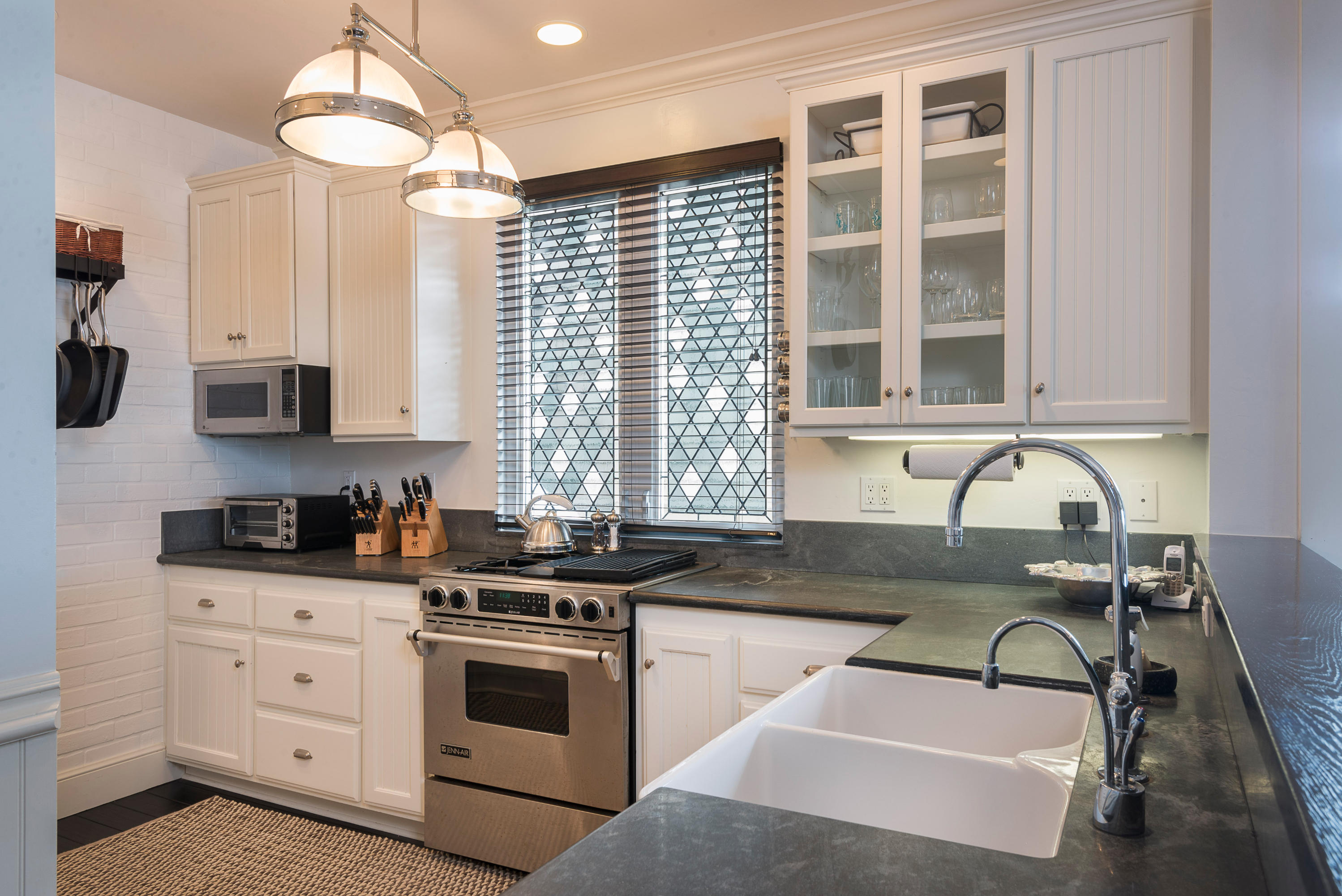 3555.5 Padaro Lane Carpinteria, CA 93013 - Photo 2 of 20 a kitchen with granite countertop a sink stainless steel appliances and cabinets