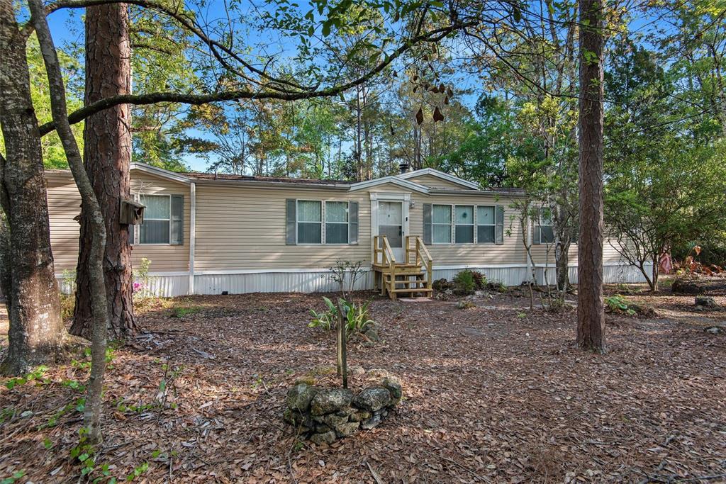 4544 Butternut Avenue Bunnell, FL 32110 - Photo 1 of 42 a view of a house with a yard tree and sitting area