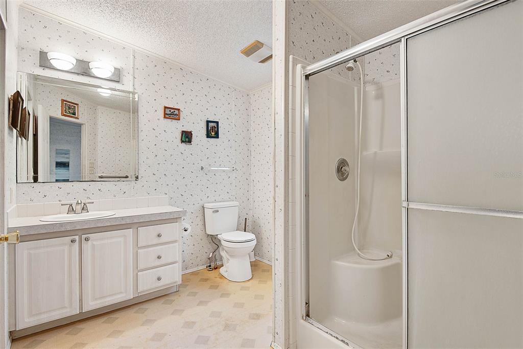 4544 Butternut Avenue Bunnell, FL 32110 - Photo 11 of 42 a bathroom with a toilet a sink and shower