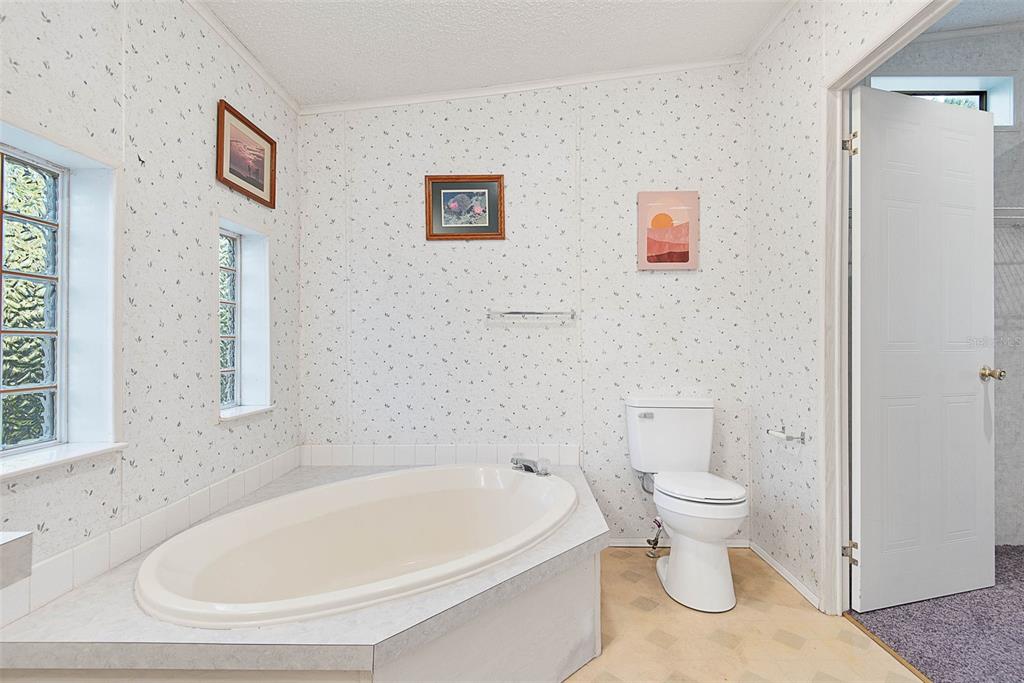 4544 Butternut Avenue Bunnell, FL 32110 - Photo 14 of 42 a white bath tub sitting next to a white toilet