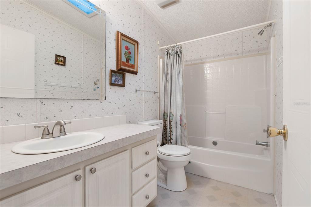4544 Butternut Avenue Bunnell, FL 32110 - Photo 19 of 42 a bathroom with a sink toilet and shower