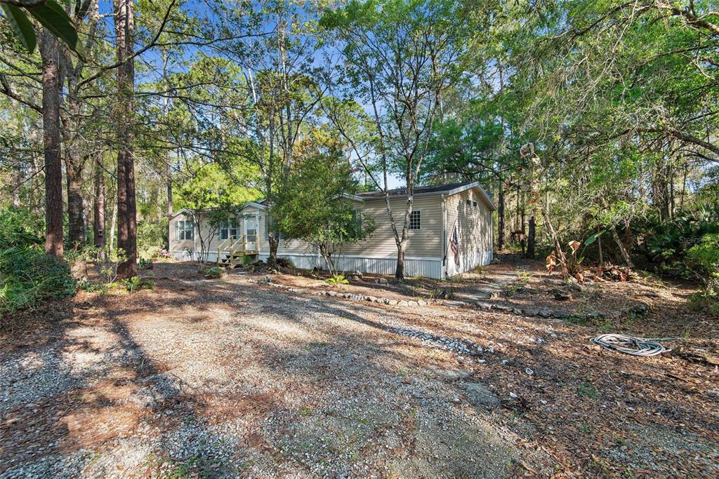 4544 Butternut Avenue Bunnell, FL 32110 - Photo 2 of 42 a view of a backyard with large trees