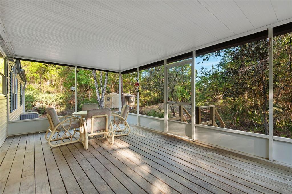 4544 Butternut Avenue Bunnell, FL 32110 - Photo 30 of 42 a dining room with wooden floor table and chairs