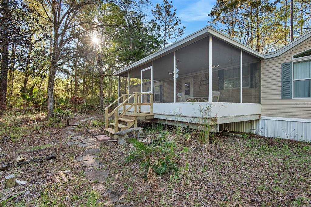 4544 Butternut Avenue Bunnell, FL 32110 - Photo 32 of 42 a backyard of a house with table and chairs