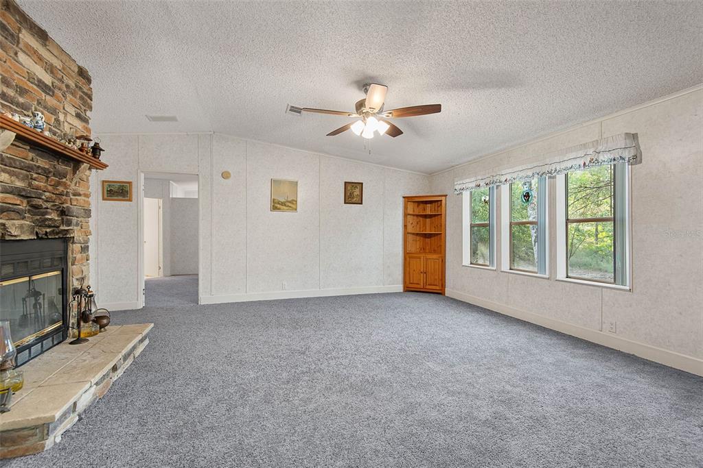 4544 Butternut Avenue Bunnell, FL 32110 - Photo 4 of 42 a view of a livingroom with a fireplace and window