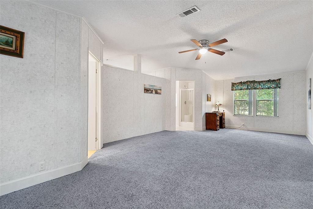 4544 Butternut Avenue Bunnell, FL 32110 - Photo 7 of 42 a view of a livingroom with a ceiling fan and window