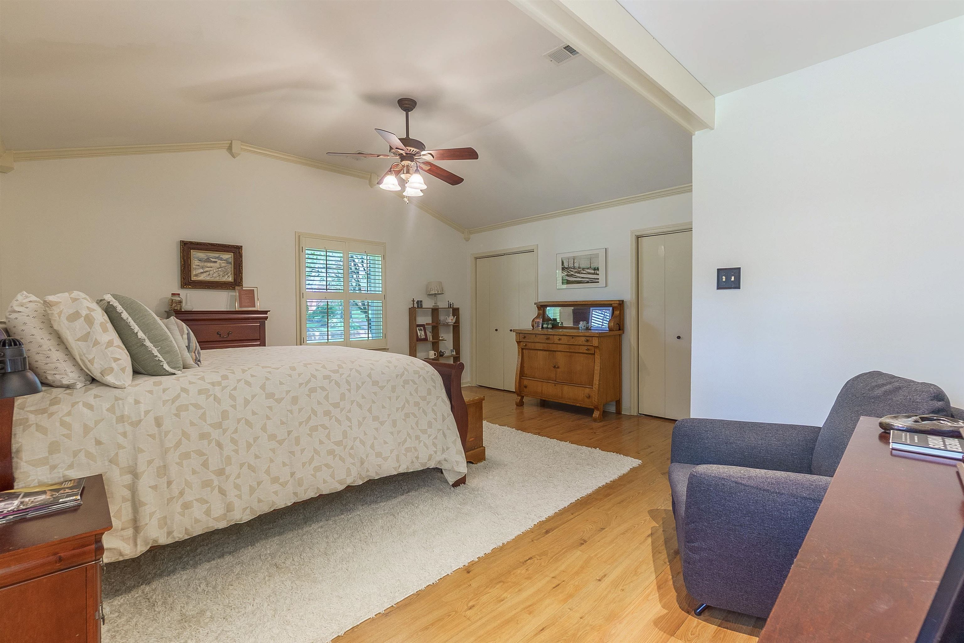 5649 Normandy Road Memphis, TN 38120 - Photo 21 of 35 a bedroom with a bed a couch and a chandelier