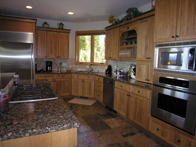 87 Ridge Road Tabernash, CO 80478 - Photo 3 of 13 a kitchen with stainless steel appliances granite countertop a stove a sink and a microwave