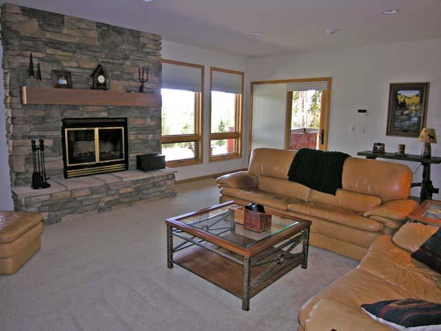 87 Ridge Road Tabernash, CO 80478 - Photo 5 of 13 a living room with furniture a fireplace and a floor to ceiling window
