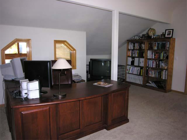 87 Ridge Road Tabernash, CO 80478 - Photo 6 of 13 a living room with furniture and a bookshelf