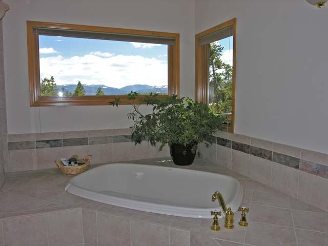 87 Ridge Road Tabernash, CO 80478 - Photo 8 of 13 a bath tub sitting in a bathroom next to a window
