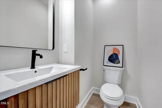 a kitchen with stainless steel appliances kitchen island granite countertop a sink a stove and a wooden floors