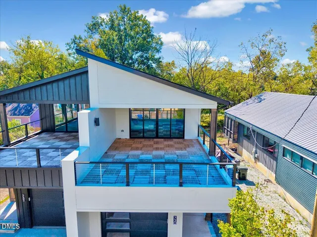 a front view of a house with a yard garage and outdoor seating