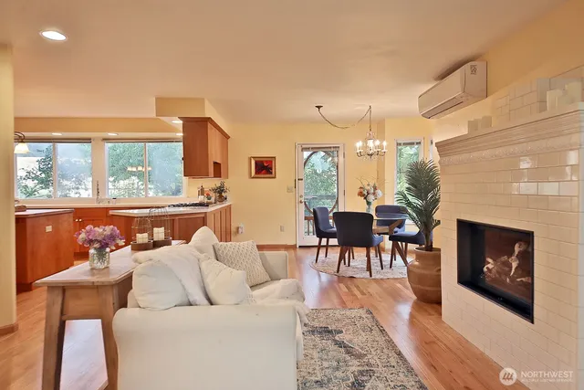 a living room with furniture a fireplace and a large window