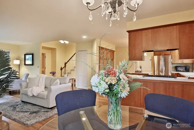 a living room with furniture chandelier and a rug