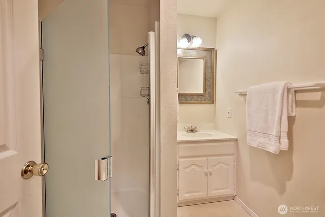 a bathroom with a sink a mirror and a shower
