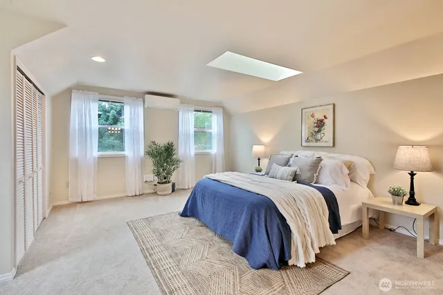 a spacious bedroom with a large bed and windows