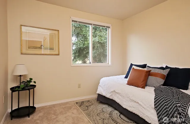 a bedroom with a bed and a window