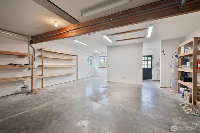 a view of an empty room with furniture and closet