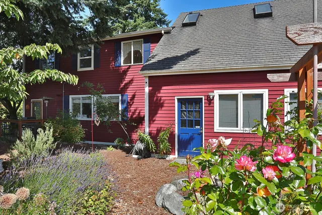a view of a house with a yard and potted plants