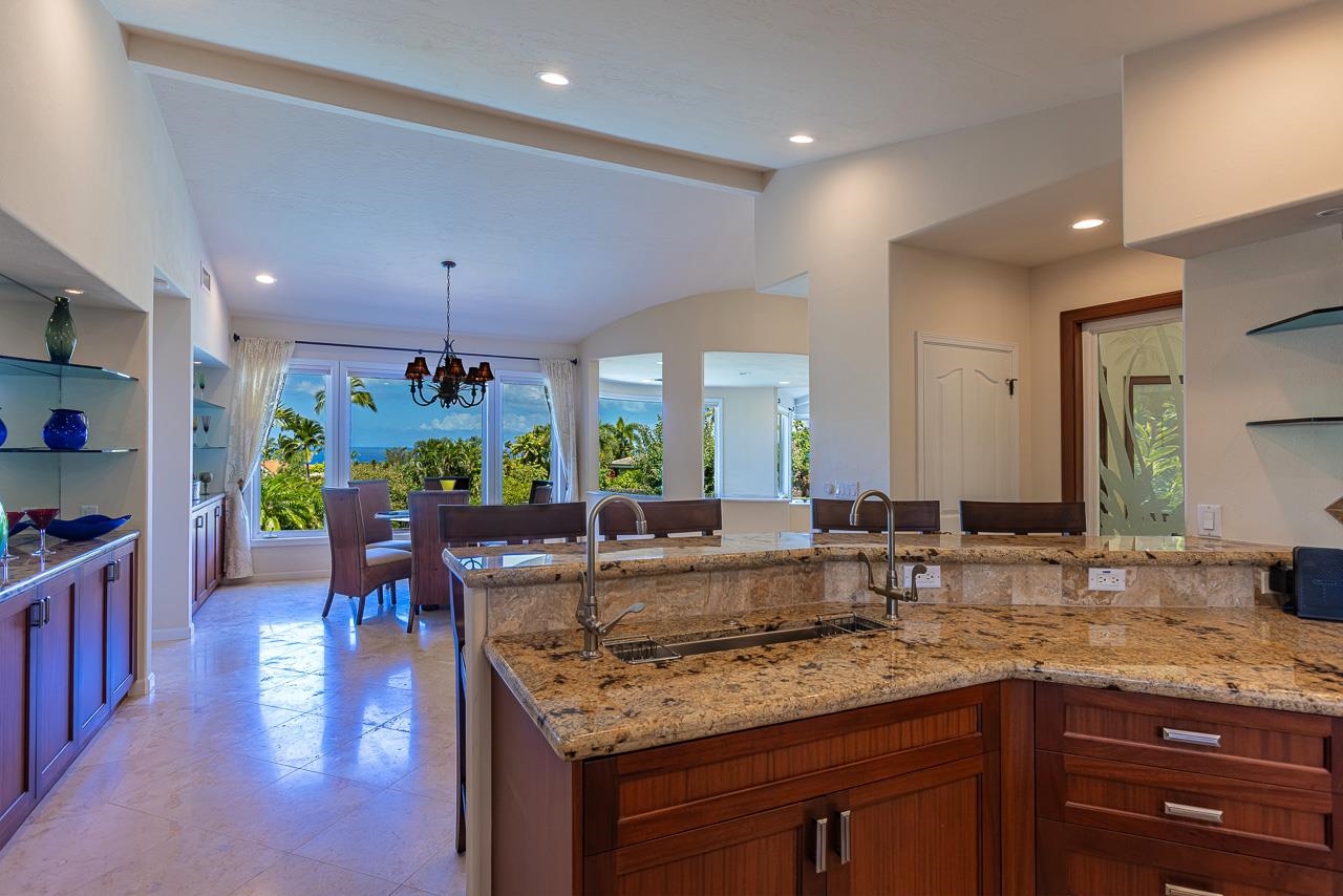 164 West Ikea Moku Place Kihei, HI 96753 - Photo 20 of 49 a kitchen with granite countertop a sink a counter top space and living room view