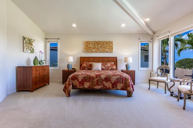 a spacious bedroom with a bed and a window