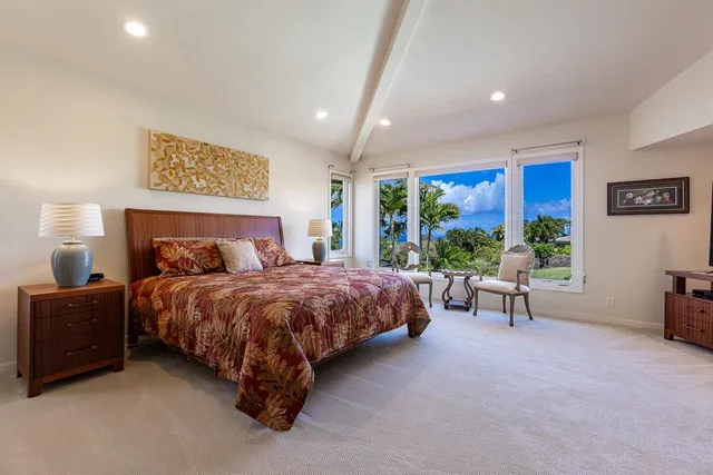 a spacious bedroom with a bed and a large mirror