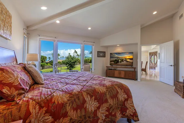 a spacious bedroom with a bed and a lamp