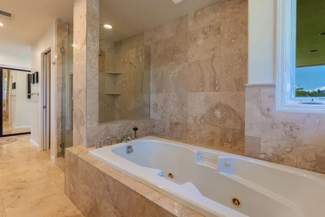 a spacious bathroom with a granite countertop sink and a mirror