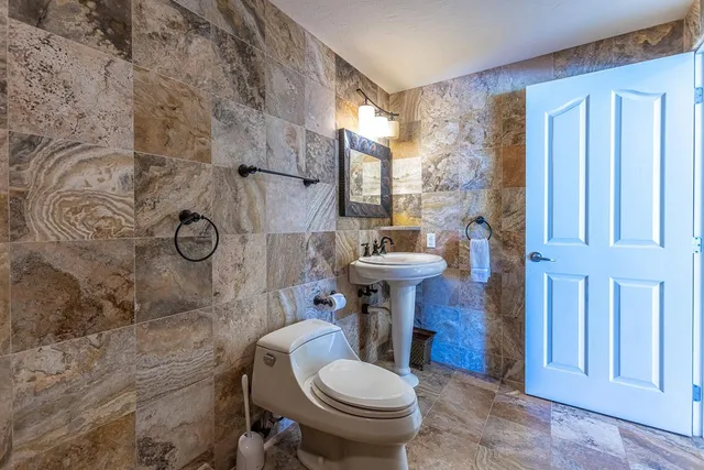 a white toilet sitting next to a shower curtain