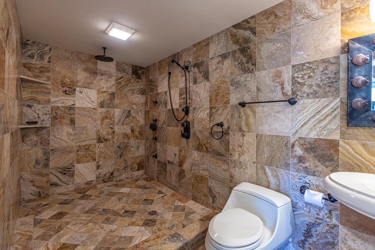 164 West Ikea Moku Place Kihei, HI 96753 - Photo 44 of 49 a white toilet sitting next to a shower curtain