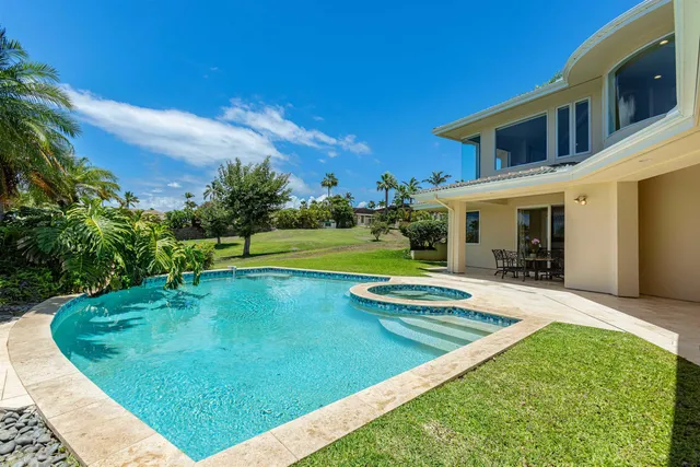 a view of a dining room with furniture a potted plant and a table