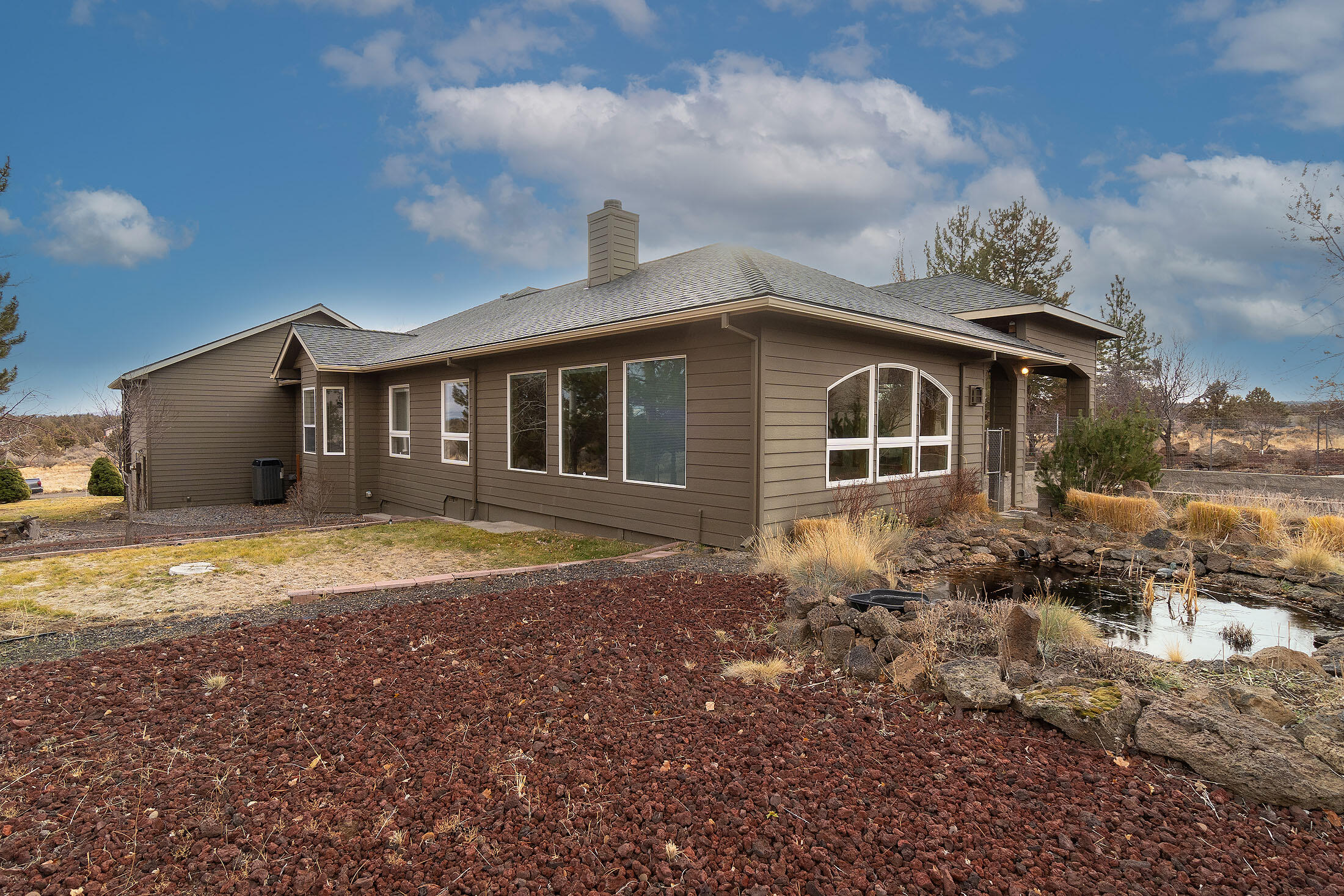 60895 Jennings Road Bend, OR 97702 - Photo 4 of 47 a front view of a house with a garden
