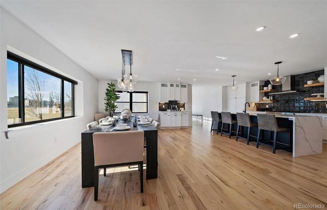 a view of a dining room with furniture window and wooden floor