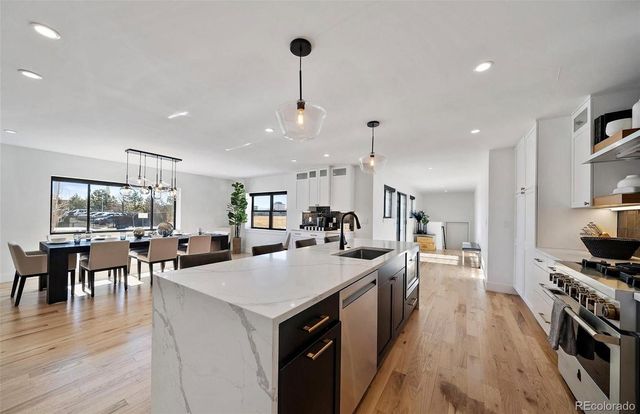 a large kitchen with a table and chairs