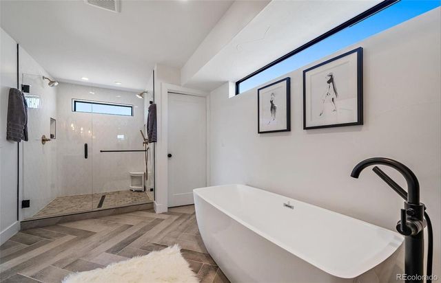 a bathroom with a bathtub and a shower