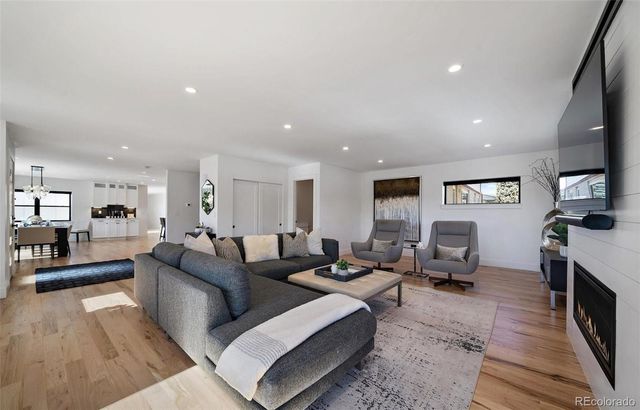 a living room with fireplace furniture and a flat screen tv
