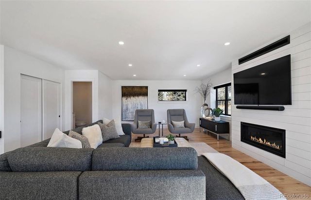 a living room with furniture fireplace and flat screen tv