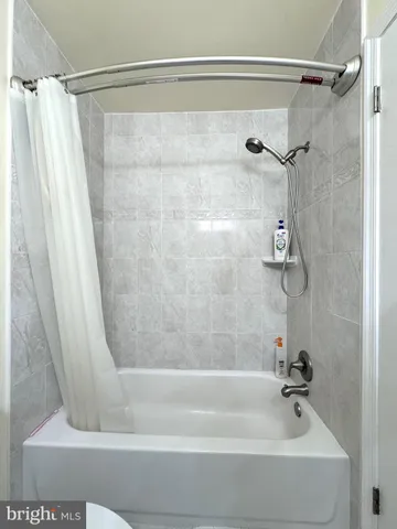 a bathroom with a shower and a bath tub