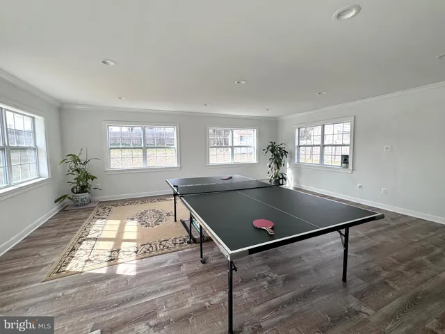 a living room with furniture a wooden floor and a window