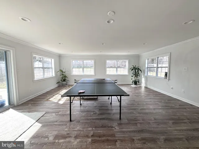 a kitchen with stainless steel appliances granite countertop a sink a stove and white cabinets