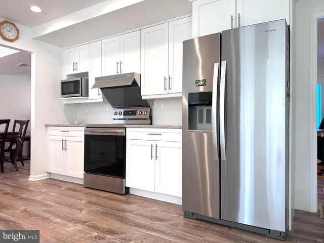 a kitchen with refrigerator and cabinets