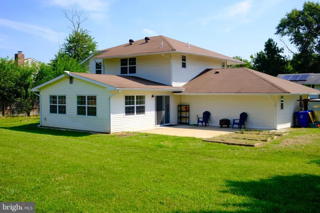 a view of a house with a yard and sitting area