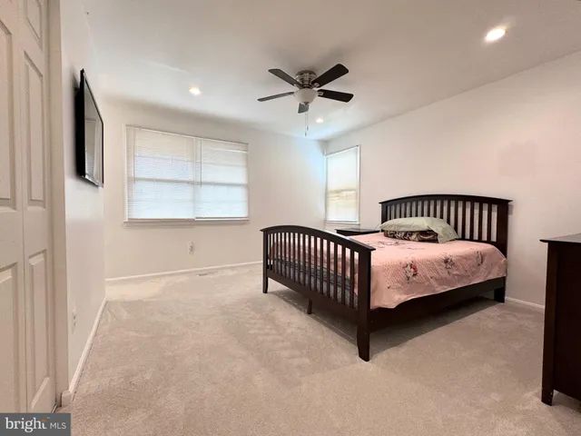 a spacious bedroom with a bed and window