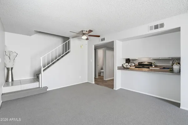 a kitchen with white cabinets and white appliances
