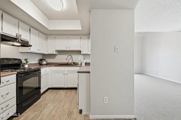 a kitchen with stainless steel appliances white cabinets and a sink