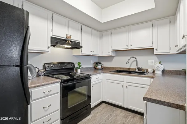 an empty room with a ceiling fan and windows